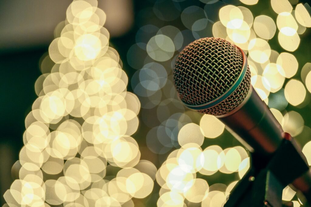 Close-up of a microphone with festive bokeh lights, perfect for holiday celebrations.